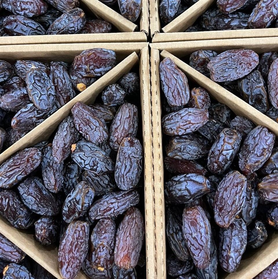 Close-up of Medjool dates sorted into cardboard packing trays