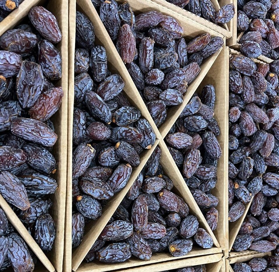 Medjool dates packed in compartmented cardboard cartons